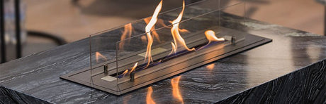Ein Tischkamin brennt hell.